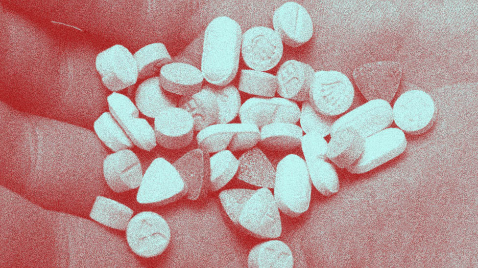 Open hand holding a variety of diffent styles of pill.