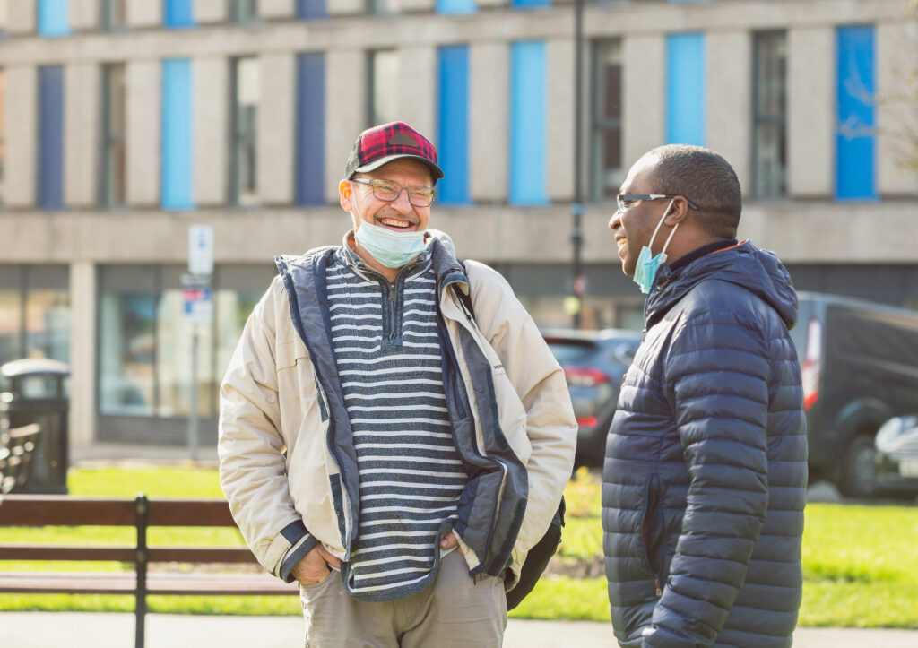 Nicky Auguste and Jan, a BDP service user, sharing a laugh outside