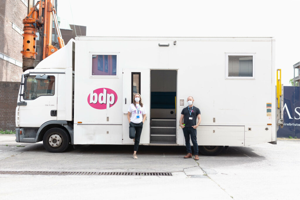 Two BDP workers stand in front of our Mobile Harm Reduction Service truck.